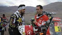 Husqvarna motorbike rider Pablo Quintanilla, of Chile, left, talks to KTM motorbike rider Gerard Farres Guell, of Spain, prior to stage 11 of the 2018 Dakar Rally between Belen and Chilecito/Fiambala, Argentina, Wednesday, Jan. 17, 2018. (AP Photo/Ricardo Mazalan)