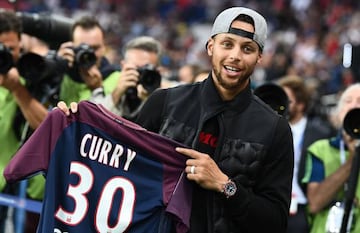 US basketball player Stephen Curry poses with a PSG jersey prior to the French L1 football match between Paris Saint-Germain (PSG) and Saint-Etienne (ASSE)