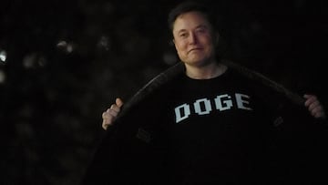 Senior Advisor to the President of the United States Elon Musk shows his shirt to the press as he arrives with U.S. President Donald Trump