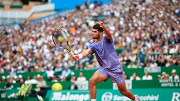 Spain's Carlos Alcaraz plays a backhand return to Spain's Alejandro Davidovich Fokina during the Monte Carlo ATP Masters Series Tournament semi-final tennis match at the Monte Carlo Country Club in Roquebrune-Cap-Martin on April 12, 2025. (Photo by Valery HACHE / AFP)