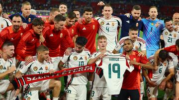 Soccer Football - Euro 2024 - Group A - Scotland v Hungary - Stuttgart Arena, Stuttgart, Germany - June 23, 2024 Hungary players celebrate after the match and hold up a shirt with Barnabas Varga's name after he was stretchered off during the match REUTERS/Leonhard Simon