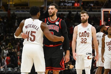 Chicago Bulls guard Zach LaVine (8) is hugged by Cleveland Cavaliers guard Donovan Mitchell (45)