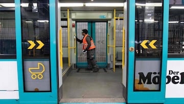 An employee of service provider PTS disinfects a tramway of the local VGF public transport authority at a depot in Frankfurt am Main, western Germany, on May 20, 2020, amid the coronavirus COVID-19 pandemic. (Photo by Yann Schreiber / AFP)