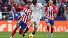 Atletico Madrid's Brazilian forward #12 Samuel Lino vies with Sevilla's Spanish midfielder #26 Juanlu Sanchez during the Spanish league football match between Club Atletico de Madrid and Sevilla FC at the Metropolitano stadium in Madrid on December 23, 2023. (Photo by Pierre-Philippe MARCOU / AFP)