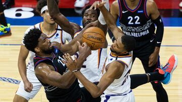 Apr 21, 2021; Philadelphia, Pennsylvania, USA; Philadelphia 76ers center Joel Embiid (21) and Phoenix Suns forward Mikal Bridges (25) battle for ball control during the first quarter at Wells Fargo Center. Mandatory Credit: Bill Streicher-USA TODAY Sports