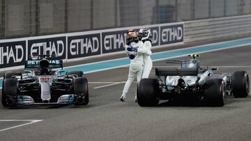 ABU DHABI, UNITED ARAB EMIRATES - NOVEMBER 26: Second place finisher Lewis Hamilton of Great Britain and Mercedes GP celebrates on track with race winner Valtteri Bottas of Finland and Mercedes GP during the Abu Dhabi Formula One Grand Prix at Yas Marina Circuit on November 26, 2017 in Abu Dhabi, United Arab Emirates. (Photo by Mark Thompson/Getty Images)