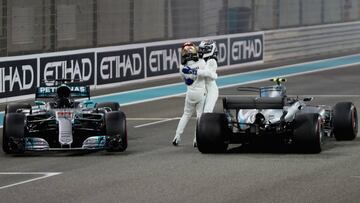 ABU DHABI, UNITED ARAB EMIRATES - NOVEMBER 26:  Second place finisher Lewis Hamilton of Great Britain and Mercedes GP celebrates on track with race winner Valtteri Bottas of Finland and Mercedes GP during the Abu Dhabi Formula One Grand Prix at Yas Marina Circuit on November 26, 2017 in Abu Dhabi, United Arab Emirates.  (Photo by Mark Thompson/Getty Images)