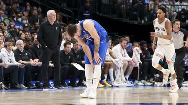Apr 10, 2022; Dallas, Texas, USA; Dallas Mavericks guard Luka Doncic (77) grabs his left calf during the second half against the San Antonio Spurs at American Airlines Center. Mandatory Credit: Kevin Jairaj-USA TODAY Sports