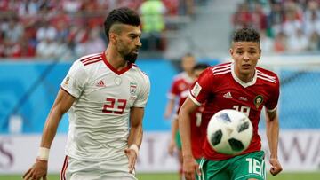 Iran's Ramin Rezaeian battles with Morocco's Amine Harit in yesterday's Group B match in Saint Petersburg.
