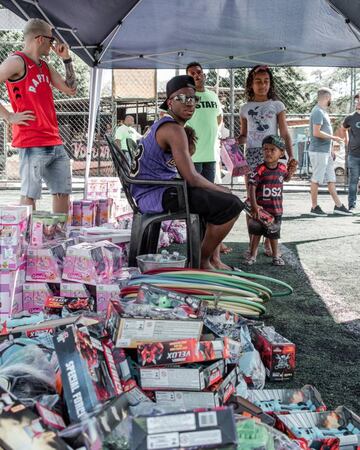 Vinicius hands out presents in Sao Paolo during Christmas.