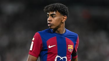 MADRID, SPAIN - APRIL 21: Lamine Yamal of FC Barcelona looks on whilst wearing a Karol G limited edition match shirt during the LaLiga EA Sports match between Real Madrid CF and FC Barcelona at Estadio Santiago Bernabeu on April 21, 2024 in Madrid, Spain. (Photo by David Ramos/Getty Images)