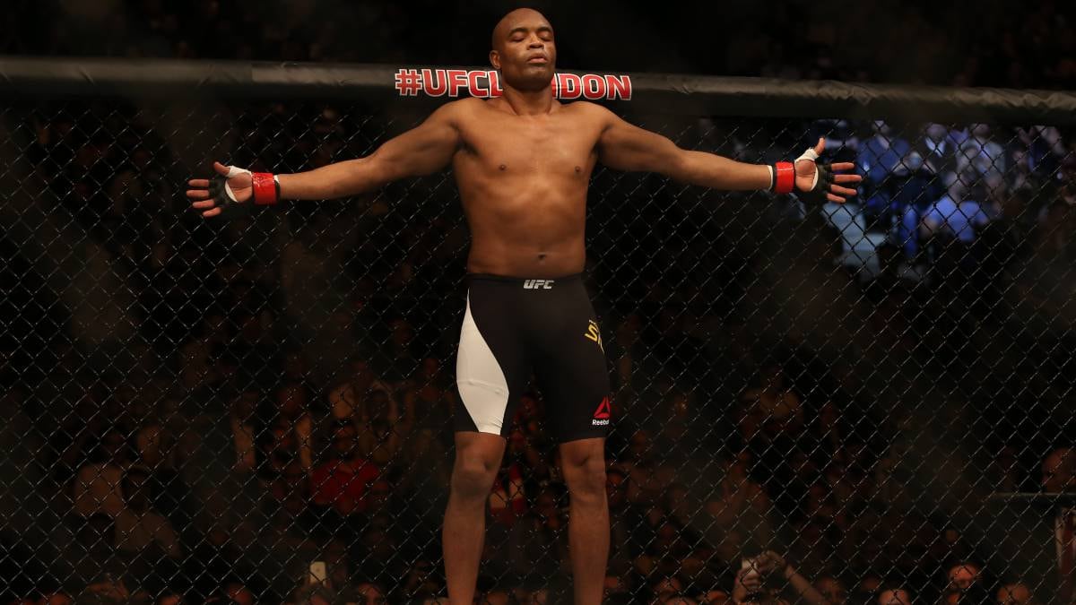Fotografía documental de Anderson Silva rezando antes de una pelea, con un enfoque en su expresión de concentración y el ambiente tenso previo al combate. Estilo fotorrealista, alta definición.
