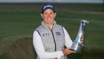 South Africa's Ashleigh Buhai poses with the trophy after her playoff win over South Korea's Chun In-gee on day 4 of the 2022 Women's British Open Golf Championship at Muirfield golf course in Gullane, Scotland, on August 7, 2022. - South Africa's Ashleigh Buhai survived a disastrous 15th hole to claim victory in a marathon play-off against Chun In-gee in the Women's British Open at Muirfield on Sunday. Both players tied on 10 under par after 72 holes, and it was Buhai who eventually secured victory in the final major of the season with a par four at the fourth extra hole, the 18th. (Photo by Neil Hanna / AFP) / RESTRICTED TO EDITORIAL USE