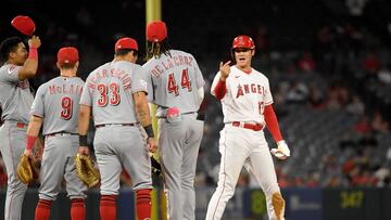 ANAHEIM, CALIFORNIA - AUGUST 23: Designated hitter Shohei Ohtani #17 of the Los Angeles Angels is greeted by Cincinnati Reds infielders Noelvi Marte #16, Matt McLain #9, Christian Encarnacion-Strand #33, and Elly De La Cruz #44 during a pitching change after Ohtani's double during the fifth of game two of a doubleheader at Angel Stadium of Anaheim on August 23, 2023 in Anaheim, California.   Kevork Djansezian/Getty Images/AFP (Photo by KEVORK DJANSEZIAN / GETTY IMAGES NORTH AMERICA / Getty Images via AFP)