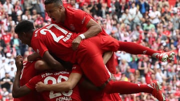 MUNICH, GERMANY - MAY 18:  Thiago (top), David Alaba and teammates of FC Bayern Muenchen celebrate Kingsley Coman&#039;s first goal during the Bundesliga match between FC Bayern Muenchen and Eintracht Frankfurt at Allianz Arena on May 18, 2019 in Munich, 