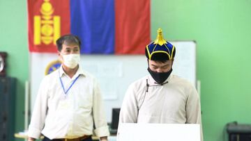 Ulaanbaatar (Mongolia), 23/06/2020.- A man (R) wearing a mask casts his vote at a polling station in Ulaanbaatar, Mongolia, 24 June 2020. Mongolian voters go to polls on 24 June 2020 to elect a new parliament amid the ongoing coronavirus pandemic. (Elecci