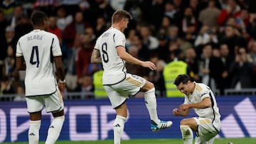 Real Madrid's Spanish forward #21 Brahim Diaz celebrates with Real Madrid's German midfielder #08 Toni Kroos after scoring his team's first goal during the Spanish league football match between Real Madrid CF and Granada FC at the Santiago Bernabeu stadium in Madrid on December 1, 2023. (Photo by OSCAR DEL POZO / AFP)