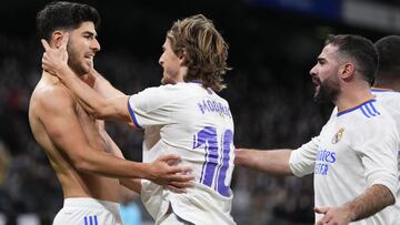 Real Madrid's Marco Asensio, left, is cheered by teammate Real Madrid's Luka Modric after scoring during a Spanish La Liga soccer match between Real Madrid and Granada at the Bernabeu stadium in Madrid, Spain, Sunday, Feb. 6, 2022. (AP Photo/Man