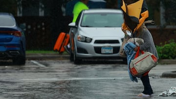 A woman holds an umbrella while arriving at a shelter as Hurricane Milton approaches, in Lakeland, Florida, U.S., October 9, 2024. REUTERS/Jose Luis Gonzalez TPX IMAGES OF THE DAY
