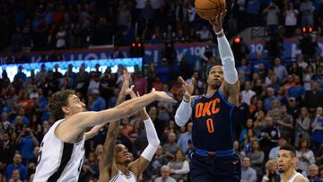 Dec 3, 2017; Oklahoma City, OK, USA; Oklahoma City Thunder guard Russell Westbrook (0) drives to the basket in front of San Antonio Spurs center Pau Gasol (16) and guard Dejounte Murray (5) during the first quarter at Chesapeake Energy Arena. Mandatory Credit: Mark D. Smith-USA TODAY Sports