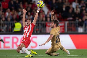 El centrocampista argentino del Almería Lucas Robertone  lucha por el balón con el centrocampista español del Barcelona Sergi Roberto.