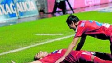 <b>EXTASIADO. </b>Diego Castro, tumbado en el césped de Riazor tras marcar el gol del Sporting, mientras es felicitado por De las Cuevas.