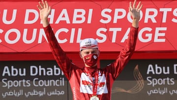 Race leader Tadej Pogacar of Team UAE Emirates on the podium after the second stage of the UAE Cycling Tour from al-Hudayriyat Island to al-Hudayriyat Island on February 22, 2021. (Photo by Giuseppe CACACE / AFP)