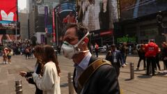 A man wears a protective face mask walking through Times Square during warnings by officials of heavy pollution after thick haze and smoke caused by wildfires in Canada covered the area, in New York City, U.S., June 8, 2023. REUTERS/Shannon Stapleton