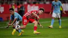GIRONA, SPAIN - AUGUST 26: Joel Roca Casals of Girona FC is tackled by Franco Cervi of RC Celta during the LaLiga Santander match between Girona FC and RC Celta at Montilivi Stadium on August 26, 2022 in Girona, Spain. (Photo by Alex Caparros/Getty Images)