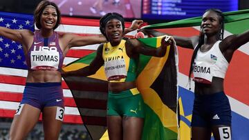 Gabrielle Thomas, Elaine Thompson-Herah and Christine Mboma celebrate with their respective national flag after the women&#039;s 200m final. 