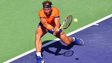 Rafael Nadal of Spain hits a backhand return to Taylor Fritz of the US in their ATP Men&#039;s Final at the Indian Wells tennis tournament on March 20, 2022 in Indian Wells, California. (Photo by Frederic J. BROWN / AFP)