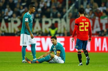 Germany’s Sami Khedira and Jerome Boateng with Spain’s Isco.