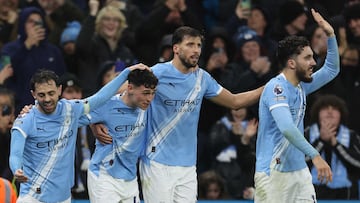Manchester City's English midfielder #47 Phil Foden (2L) celebrates scoring the team's third goal with Manchester City's Portuguese midfielder #20 Bernardo Silva (L), Manchester City's Portuguese defender #03 Ruben Dias (2R) and Manchester City's French midfielder #10 Rayan Cherki during the English Premier League football match between Manchester City and Sunderland at the Etihad Stadium in Manchester, north west England, on December 6, 2025. (Photo by Darren Staples / AFP) / RESTRICTED TO EDITORIAL USE. No use with unauthorized audio, video, data, fixture lists, club/league logos or 'live' services. Online in-match use limited to 120 images. An additional 40 images may be used in extra time. No video emulation. Social media in-match use limited to 120 images. An additional 40 images may be used in extra time. No use in betting publications, games or single club/league/player publications. /