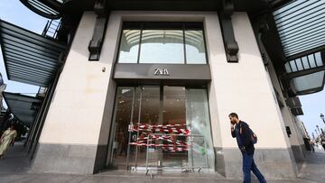 A man walks past the damaged entrance of a Zara store vandalised during a night of clashes between protesters and police following the death of Nahel, a 17-year-old teenager killed by a French police officer in Nanterre during a traffic stop, at Rue de Rivoli in Paris, France, June 30, 2023. REUTERS/Yves Herman