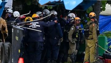 Rescue workers continue to search through rubble at the site of a collapsed building in Surfside, Florida, north of Miami Beach on June 27, 2021. - The death toll after the collapse of a Florida apartment tower has risen to nine, officials said Sunday, wi