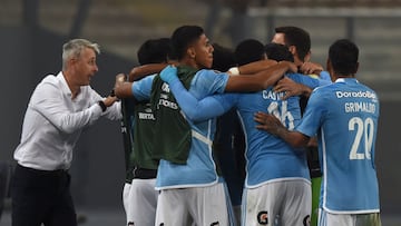 Sporting Cristal's Brazilian coach Tiago Nunes (L) gives instructions to players as they celebrate after teammate Jhilmar Lora (covered) scored his team's first goal during the Copa Libertadores group stage first leg football match between Peru's Sporting Cristal and Bolivia's The Strongest, at the National stadium in Lima, on May 2, 2023. (Photo by CRIS BOURONCLE / AFP)