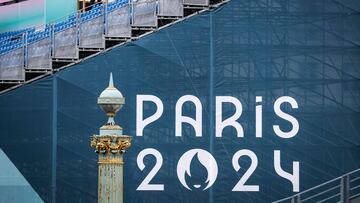 A worker checks a stand in front of a banner at the 3x3 basketball venue located at the La Concorde, in Paris on July 23, 2024, ahead of the 2024 Paris Olympic Games. (Photo by DAVID GRAY / AFP)