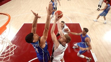 Team Germany goes up for a shot  against Simone Fontecchio #13 of Team Italy during the first half on day two of the Tokyo 2020 Olympic Games .