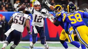 New England Patriots quarterback Tom Brady (12) makes a quick pass before he is almost sacked by Los Angeles Rams defensive end Aaron Donald (99) in the first quarter of Super Bowl LIII at Mercedes-Benz Stadium on February 3, 2019 in Atlanta.   *** Local Caption *** .