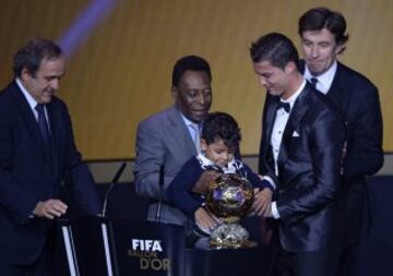 Pelé, durante la entrega del Balón de Oro 2013 a Cristiano Ronaldo,, juega con el hijo de este ante la presencia de Michel Platini.