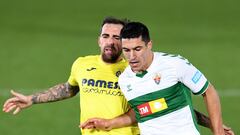 VILLAREAL, SPAIN - DECEMBER 06: Diego Gonzalez of Elche CF is challenged by Paco Alcacer of Villarreal CF during the La Liga Santander match between Villarreal CF and Elche CF at Estadio de la Ceramica on December 06, 2020 in Villareal, Spain. Sporting st