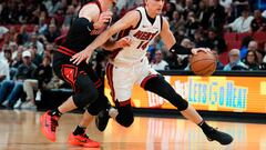 MIAMI, FLORIDA - APRIL 19: Tyler Herro #14 of the Miami Heat dribbles the ball against Alex Caruso #6 of the Chicago Bulls in the first quarter during the Play-In Tournament at Kaseya Center on April 19, 2024 in Miami, Florida. NOTE TO USER: User expressly acknowledges and agrees that, by downloading and or using this photograph, User is consenting to the terms and conditions of the Getty Images License Agreement.   Rich Storry/Getty Images/AFP (Photo by Rich Storry / GETTY IMAGES NORTH AMERICA / Getty Images via AFP)