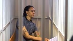 US Women's National Basketball Association (NBA) basketball player Brittney Griner, who was detained at Moscow's Sheremetyevo airport and later charged with illegal possession of cannabis, sits inside a defendants' cage after the court's verdict during a hearing in Khimki outside Moscow, on August 4, 2022. - A Russian court found Griner guilty of smuggling and storing narcotics after prosecutors requested a sentence of nine and a half years in jail for the athlete. (Photo by EVGENIA NOVOZHENINA / POOL / AFP)