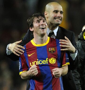 Guardiola (R) celebrates with Messi after the Champions League semi-final second leg football match between Barcelona and Real Madrid at the Camp Nou stadium in Barcelona on May 3, 2011.