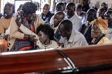 La madre de Kelvin Kiptum, Mary Kangongo (2.a izq.), es consolada por otros miembros de la familia durante una misa en memoria del difunto. 