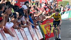 Team Jumbo-Visma's US rider Sepp Kuss slaps hands with spectators as he celebrates winning the sixth stage of the 2023 La Vuelta cycling tour of Spain, a 183,1 km race from La Vall d'Uixo to Alto de Javalambre, on August 31, 2023. (Photo by JOSE JORDAN / AFP)