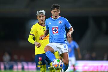 Cristian Calderon (L) of America fights of the ball kith Lorenzo Faravelli (R) of cruz Azul during the Semi-Final first leg match between Cruz Azul and America as part of the Liga BBVA MX, Torneo Clausura 2025 at Olimpico Universitario Stadium on May 15, 2025 in Mexico City, Mexico.