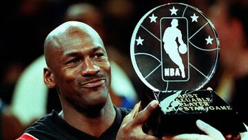 Chicago Bulls' Michael Jordan holds up the Most Valuable Player trophy which he earned in leading the Eastern Conference to victory in the NBA All-Star Game at Madison Square Garden 08 February. Jordan won his third MVP award by scoring 23 points as