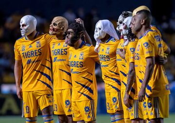 Un grupo de jugadores de Tigres posa en el terreno de juego con máscaras de Halloween en los momentos previos al inicio del partido entre Tigres de UANL y Chivas de Guadalajara. El encuentro, correspondiente a la jornada 16ª del Torneo Apertura, tuvo lugar ayer en el estadio Universitario de la ciudad de Monterrey (México).