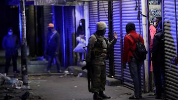 A member of the South African military talks to a man during a patrol in Johannesburg. 